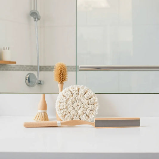 Bathroom cleaning tools neatly arranged near a shower tile and glass surface